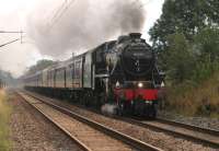 45231, on its first appearance on <I>The Fellsman</I> in 2014, hurries along the WCML at Woodacre trying to keep out of the way of following TPE and Virgin services. The train was only steam hauled on the return journey due to an FBU strike and had been taken to Carlisle in the morning by EE Type 3, 37518, now idling on the rear. <br><br>[Mark Bartlett 13/08/2014]