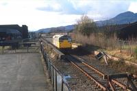 26040 at Cambus on 21 March 1988 in the process of running round a short train to/from Glenochil Yeast at Menstrie. By this time the signal box had been demolished, buffer stops were installed on the former through route to Alloa yard and Cambus level crossing was closed to rail traffic. Note the felled signal post on the right. The locomotive is now privately preserved. <br><br>[Ewan Crawford Collection 21/03/1988]