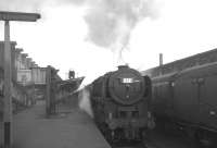 An unidentified member of Kingmoor shed's allocation of Britannia Pacifics has just taken over the 12.55 from London Euston at Carlisle on 31 July 1965. The locomotive is about to take the train forward to Glasgow Central.<br><br>[K A Gray 31/07/1965]