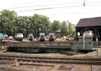 The turntable and diesel shed at Bebra in July 1990 with a collection of Class 216s, a class 290 and three Class 261/360 0-6-0 shunters. To the right (south) was the electric shed complete with its own turntable [see image 22506].<br><br>[John McIntyre /07/1990]