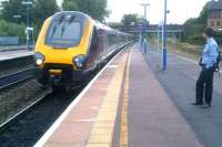 The 06.33 Birmingham New Street - Southampton Central CrossCountry Voyager breezes into the platform at Banbury during an overcast morning on 6th August 2014. The headlight visible under the bridge is on a DVT on a loco-hauled set. [see image 41185]<br><br>[Ken Strachan 06/08/2014]