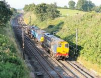 20304 leads the morning Crewe to Sellafield flask train through the cutting at Forton on 11 July. Tucked in behind the Type 1 is 57008 followed by a single flask. The Class 57 led the pair on the return to Crewe with the evening service.<br><br>[Mark Bartlett 11/07/2014]