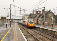 A grey day at Lockerbie on 4 April 2014 as 11-car <I>Pendolino</I> 390136 hurries through the station with a London Euston to Glasgow Central service.<br><br>[Mark Bartlett 04/04/2014]