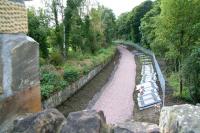 Neat looking trackbed running south from the A6106 road bridge towards Eskbank on 24 August 2014, photographed from the wall alongside the recently raised bridge parapet.<br><br>[John Furnevel 24/08/2014]