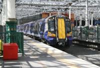 380104 recently arrived at Waverley platform 4 as the 1227 ex-North Berwick on a bright and sunny 22 August 2014. On a day such as this the impact of all the work carried out on the station roof can really be appreciated [see image 36223].<br><br>[John Furnevel 22/08/2014]