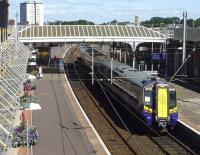 ScotRail 380003 stands in the sunshine at Ayr station's platform 4 on 26 August 2014.<br><br>[John Steven 26/08/2014]