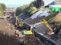 Waverley trackbed alongside the Lady Victoria site on 30 August 2014, with Newtongrange station taking shape this side of the A7 road bridge in the background.<br><br>[John Furnevel 30/08/2014]