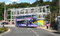 A First Bus X62 service for Edinburgh via Peebles stands in front of the under-construction travel interchange on Stirling Street, Galashiels, on 31 August 2014. Bus stances will eventually be formed in front of the building, while the railway station platform will stand directly behind on the other side of the A7 [see image 48574].<br><br>[John Furnevel 31/08/2014]