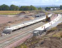 Sleepers being set out through Shawfair station on 1 September 2014, view south.<br><br>[Bill Roberton 01/09/2014]