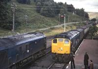 <I>Scottish Grand Tour No. 9</I> was booked to pass the 11:10 from  Kyle of Lochalsh at Garve, giving the opportunity to photograph the tablet exchange as the latter train, headed by D5130, entered the station. The leading locomotive on the rail tour is D5120 which along with D5117 had replaced D5071 and D5342 at Rose Street Junction in Inverness.<br><br>[Bill Jamieson 13/09/1969]