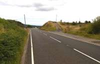 A short walk South from Blaenavon High Level station gives you a choice: steadily down to Newport, or up a once-notorious 1 in 22 to Varteg Hill colliery. This is where the colliery line crossed the B4246 Varteg Road, between Blaenavon and Abersychan. The steep rise of the Eastern Valley is shown by the view of the Mendip Hills above the approaching cars - the Mendips are 40 miles away, across the Bristol Channel. View looks South.<br><br>[Ken Strachan 24/08/2014]