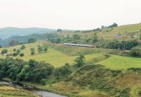 High above the River Lune a <I>Super Voyager</I> rounds the bend into the Lune Gorge and passes Dillicar Common as it heads north on what is, despite the adjacent M6 Motorway, one of the most scenic stretches of the Lancaster and Carlisle Railway.<br><br>[Mark Bartlett 05/09/2014]