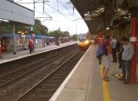 The 19.29 for Euston rushes into Oxenholme on Saturday evening 6 September. The class 185 at platform 3 on the far left is about to depart for Windermere [see image 27663].<br><br>[Ken Strachan 06/09/2014]