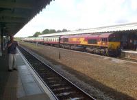 <I>It's over there...</I> the photographer is clearly more interested in the unit for Cambridge than the Pathfinder Tours <I>Anglian Explorer</I> at Bury St Edmunds on 6 August. The latter, topped and tailed by class 66s, is in the process of setting back into the platform from the loops ready for departure.<br><br>[Ken Strachan 06/08/2014]