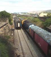 Final clear-up from the derailment of the up Sleeper at Prestonpans in the early hours of 22 May 1980. Nine sleeper coaches had been derailed after a length of rail was placed across the track by a local youth, injuring 27 people and closing the ECML for 4 days. Blindwells opencast site stands in the background.<br><br>[Bruce McCartney /05/1980]