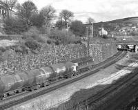 An empty oil train, headed by 47285 and probably bound for Teesside, approaches Marsden station off the sharp reverse curves at the east end of Standedge Tunnel. Thought to have been taken in the winter of 1983 - 84.<br><br>[Bill Jamieson /11/1983]