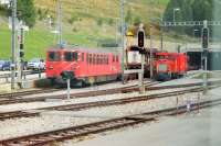 Grab shot of the Furka Base Tunnel (west end) car loading terminal from a passing Glacier Express service. The 15km tunnel, at an altitude of 4500', replaced the Furka Summit tunnel at 7100' and its opening in 1982 allowed year round operations on the line rather than summer only. The vehicle carrying shuttle trains operate a frequent service through the tunnel avoiding the steep climb and descent of the Furka Pass.     <br><br>[Mark Bartlett 14/09/2013]