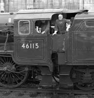 The fireman of 46115 <I>Scots Guardsman</I> (who seems to be kitted out with a pristine pair of outsize 'Marigold' washing-up gloves!) gazes out from the cab at Carlisle on 24 October 2009. 46115 had worked <I>The Hadrian</I> charter (which had originated in Leicester) from Hellifield and would take it on to York via Hexham.<br><br>[Bill Jamieson 24/10/2009]