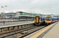 Typical motive power line up at Blackpool North in September 2014, with a TransPennine 185 alongside a Northern 158 and a 156 also in the station. Behind, on the hill, the new buildings overlooking the station are part of the town centre regeneration. <br><br>[Mark Bartlett 15/09/2014]