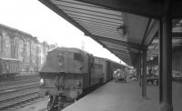 Parcels activity has taken over Carlisle platform 1 on this occasion in the summer of 1966. The Ivatt class 2MT 2-6-2T on station pilot duty is thought to be Upperby locomotive 41229.<br><br>[K A Gray //1966]