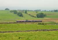 A TPE 350 EMU, bound for Manchester Airport, runs through the open countryside between Harrisons Sidings and Shap village on 20th September. The Lake District Fells, normally clearly visible in the distance from the vantage point on the A6 road, are hidden beneath low cloud on this occasion. <br><br>[Mark Bartlett 19/09/2014]