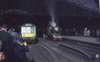 A sunny morning at St Enoch station on 30 March 1964 sees the SLS <I>Scottish Rambler No 3</I> railtour awaiting its departure time behind NB 256 <I>Glen Douglas</I>.<br><br>[John Robin 30/03/1964]