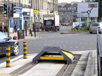 The buffer at Edinburgh Trams York Place terminus on 23 September. The road sign in the background points the way for the delayed Leith extension.<br><br>[Bill Roberton 23/09/2014]