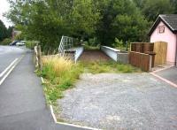 The Midland Railway branch to Ripley crossed Duffield Road, Little Eaton, at an oblique angle until the end of the coal trains to Denby [see image 26040] in 1999. The whole area is now built over, but this bridge remains, along with the distinctly pink station building, to the right. View looks north east towards Denby.<br>
<br><br>[Ken Strachan 13/09/2014]