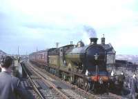 NBR 256 <I>Glen Douglas</I> with <I>Scottish Rambler no 3</I> during a photostop at Drumshoreland station on 30 March 1964. Originally opened as Broxburn in 1849 the name change occurred in 1870. The station, which closed to passengers in 1951, was located in the shale mining centre of West Lothian, signs of which can be seen on both sides of the picture. <br><br>[John Robin 30/03/1964]