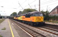 The 6V38 Ribblehead to Chirk log train operated by Colas Rail Freight heads through Leyland on 20 September 2014. The train had been held at Farington Junction before joining the WCML for the run as far as Warrington. Class 56s, 096 and 105 are providing the necessary power and insurance.<br><br>[John McIntyre 20/09/2014]