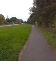 Looking along the B6179 Alfreton Road towards Derby, you may notice that the pavement is broad, and a long way from the road. It is built on the trackbed of a tramroad, which carried coal from <br>
Kilburn and Denby collieries before the MR Ripley branch took over that traffic. It opened in 1795 at 3 foot 6 inch gauge, and closed in 1908 after regauging to 4 foot. The trackbed curved away from the road towards the Derby canal approximately where the estate agent's sign can be seen to the right.<br><br>[Ken Strachan 13/09/2014]