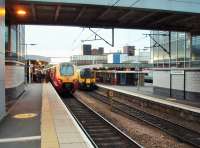 A first light view of the <I>New</I> platform at Wolverhampton (High Level) showing Voyager 221116, recently arrived from Preston, alongside London Midland 350249 waiting to leave for Northampton. The difference in height of the tracks in platforms 3 and 4 is very noticeable. <br><br>[Mark Bartlett 25/09/2014]