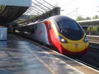 Pendolino 390115 waits at platform 11 at Crewe on 30 September with the 3 minutes late 07.43 service from Euston, via Birmingham, to Glasgow Central.<br><br>[David Pesterfield 30/09/2014]