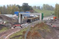 View from the north end of Millerhill Yard looking south west towards Shawfair on Sunday 5 October 2014, with a trainload of track ready for laying standing on the up line just beyond the new bridge.<br><br>[John Furnevel 05/10/2014]