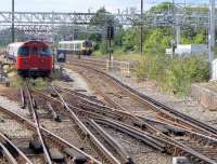 Harrow and Wealdstone is the northern terminus of the Bakerloo Line with parallel platforms on the WCML.  A London Underground train reverses in the sidings on 28 July while a London Midland 350 passes on the main line.<br><br>[Bill Roberton 28/07/2014]