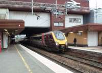 <I>Super Voyager</I> 221119 pulls away from Birmingham International with a CrossCountry Bournemouth to Manchester Piccadilly service on 25 September. The elevated <I>Sky-Rail</I> link to the Airport starts from the grey building top right.<br><br>[Mark Bartlett 25/09/2014]