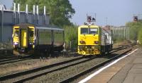 MPV DR98911 awaits the right away at Kilmarnock on 17 September during a test run, as 156439 arrives with a Glasgow Central - Newcastle Central service.<br><br>[Ken Browne 17/09/2014]