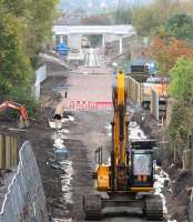 Looking south along the Waverley trackbed from the A6094 road bridge on 5 October 2014 towards the new Eskbank station. Sleepers have now been laid from a point just beyond the metal barriers marking the pedestrian crossing point. <br><br>[John Furnevel 05/10/2014]