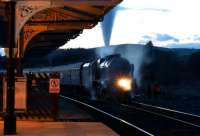 The sun has gone down at Hellifield on 4 October as 46115 <I>Scots Guardsman</I> waits in the shadows with the return <I>Lune Rivers Trust</I> charter as it takes on water.<br><br>[John McIntyre 04/10/2014]