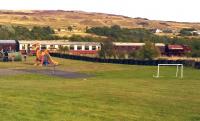 A plastic dragon and a collection of slag heaps - we could, perhaps, be West of the Severn. 'Mechanical Navvies Limited' prepares to take the 3pm down train away from Whistle Inn halt in August 2014. There is a tramway tunnel under the hill in the background.<br><br>[Ken Strachan 24/08/2014]