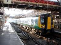 London Midland pioneer Siemens Desiro class 350 101 starts out from down side stabling bay platform 8 at Crewe, rather than the normal up side bay platform 4, with the 10.02 stopping service to London Euston via Stoke on Trent and Stafford.<br><br>[David Pesterfield 30/09/2014]