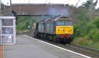 DRS 57002+57008 with the 6M22 Hunterston to Sellafield nuclear flasks passing through Ardrossan South Beach station on 13 August 2014.<br><br>[Ken Browne 13/08/2014]