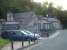 Evening view north west along the access road off Llangefni High Street on 23 July showing the former station house and station buildings. The station yard now forms part of a large car park.<br><br>[David Pesterfield 23/07/2014]