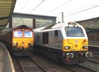 66030 runs through Carlisle platform 4 with a southbound freight on Saturday 11 October 2014. Standing on the centre road is 67029 <I>Royal Diamond</I>, one of the diesel locomotives on drag duty between Carlisle and Newcastle during closure of the ECML for engineering works. [See image 49004] <br><br>[Kevin McCartney 11/10/2014]