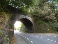 Close up of the skew bridge on the former Holmfirth branch that crosses the A616 Sheffield to Huddersfield Road on the southern outskirts of Brockholes. View north in September 2014, showing the harshness of the curves facing road traffic. [See image 48869]<br><br>[David Pesterfield 28/09/2014]