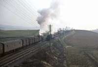 Looking east from the A76 road bridge at New Cumnock on 2 April 1965, with the station behind the camera. Black 5 45235 on an up parcels train meets classmate 44796 with a freight.  [Ref query 14931] <br><br>[John Robin 02/04/1965]