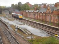 Looking north over the former Rotherham Masborough station on 13 October 2014 as 47815 hauls 59003 <I>Yeoman Highlander</I> south to Eastleigh Works from Immingham docks. The ex-Foster Yeoman class 59 had been repatriated from Germany following purchase by GBRf.  <br><br>[David Pesterfield 13/10/2014]