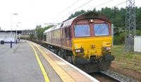 DB Schenker 66119 passing south through Carstairs on 4 September 2014 with the 6E30 Dalzell steelworks to Tees Yard steel slabs and scrap.<br><br>[Ken Browne 04/09/2014]