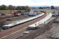 View south over Shawfair Station on 14 October, with 66605 waiting with an empty autoballaster.<br><br>[Bill Roberton 14/10/2014]