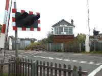 Barrington Road level crossing on 25 May 2004. Across the road is Bedlington North signal box and in the left background the remains of Bedlington station.  Just beyond the box the line splits at Bedlington North Junction with the Ashington line on the left and the line to Morpeth running off to the right behind the fence. View is south east towards Blyth. [See image 6364]<br><br>[John Furnevel 25/05/2004]